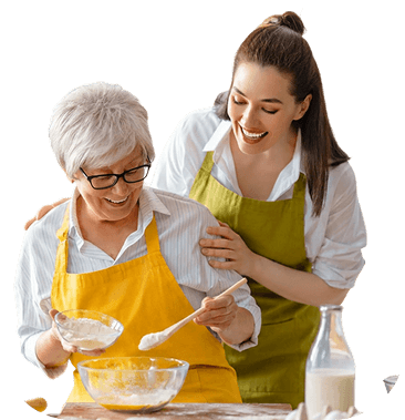 Elderly Woman Baking With Her Daughter in the Kitchen at an Independent Living Community