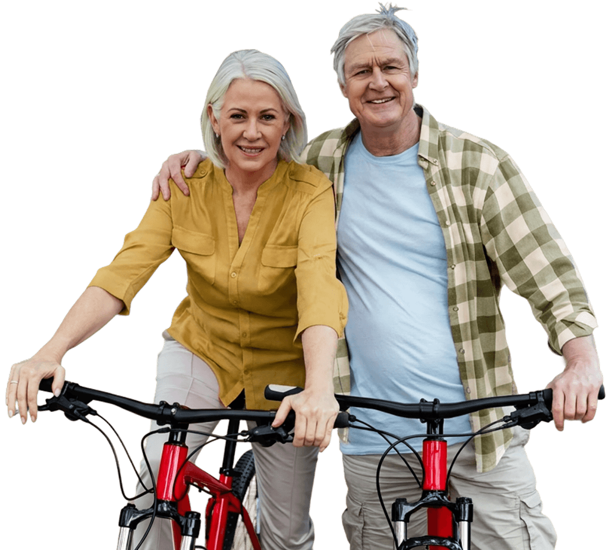 Smiling Elderly Couple Riding Bicycles Together Outdoors Near an Independent Living Facility Smiling Elderly Couple Riding Bicycles Together Outdoors Near an Independent Living Facility