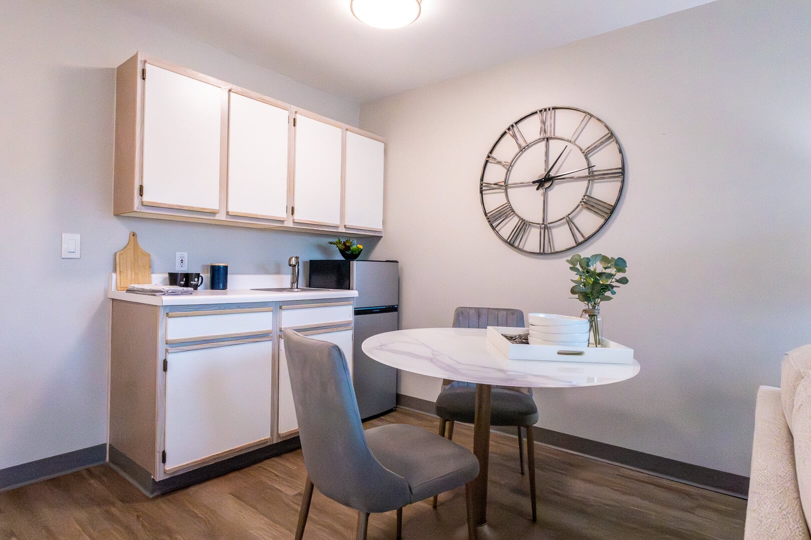 Compact Apartment Kitchenette With Dining Table at an Independent Living Facility