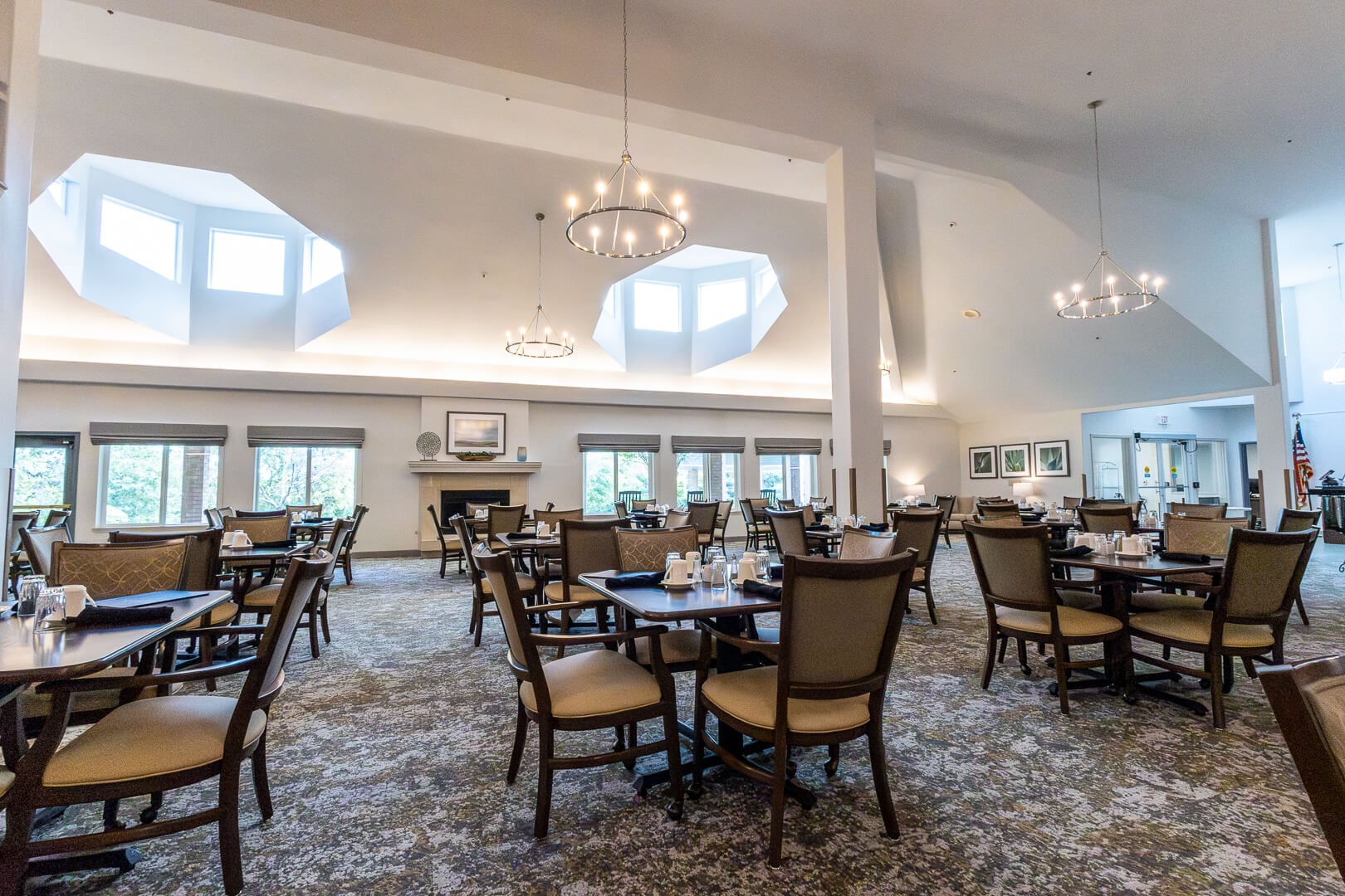 Large Dining Room With Skylights and Fireplace at an Independent Living Facility