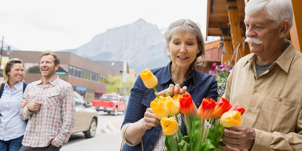 Elderly Couple Admiring Tulips at Local Flower Market near Independent Living Facility